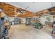 Spacious garage features an abundance of storage space, workbench, and riding mower at 2600 Gemway Dr, Charlotte, NC 28216