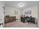Functional home office features desk, printer, storage cabinet, and carpeted floors at 2600 Gemway Dr, Charlotte, NC 28216