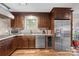 Well-equipped kitchen offers granite countertops, stainless dishwasher and refrigerator, and wooden cabinets at 2600 Gemway Dr, Charlotte, NC 28216
