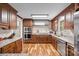 Gourmet kitchen featuring stainless appliances, granite counters, custom cabinetry and hardwood floors at 2600 Gemway Dr, Charlotte, NC 28216
