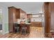 Modern kitchen with dark wood cabinets, granite countertops, stainless steel appliances, and hardwood floors at 2600 Gemway Dr, Charlotte, NC 28216