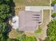 Aerial view of a home showcasing the roof, driveway, backyard patio with fire pit, and surrounding greenery at 2751 Collaroy Rd, Waxhaw, NC 28173