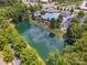 An aerial view showing a community pool and clubhouse complex nestled by a pond and lush trees at 2751 Collaroy Rd, Waxhaw, NC 28173