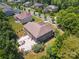 An aerial view of a two-story brick home showcasing its backyard, patio, and surrounding landscape at 2751 Collaroy Rd, Waxhaw, NC 28173