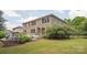 A two-story brick home features a large backyard with a patio area and lush landscaping at 2751 Collaroy Rd, Waxhaw, NC 28173