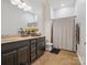 Bathroom features a granite vanity and a shower with decorative shower curtain at 2751 Collaroy Rd, Waxhaw, NC 28173