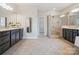 A modern bathroom with double vanity, glass shower, and tile flooring at 2751 Collaroy Rd, Waxhaw, NC 28173