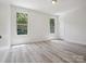 A spacious bedroom with hardwood flooring and two windows allowing lots of natural light at 2751 Collaroy Rd, Waxhaw, NC 28173