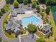 An aerial view of a neighborhood pool with a slide, recreational pool, lounge chairs, and a clubhouse at 2751 Collaroy Rd, Waxhaw, NC 28173