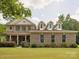 Charming brick home with a landscaped lawn and inviting front porch, featuring dormer windows and a classic design at 2751 Collaroy Rd, Waxhaw, NC 28173
