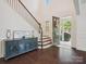 Bright foyer with hardwood floors, staircase, and decorative console table, leading to an open front door at 2751 Collaroy Rd, Waxhaw, NC 28173