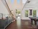 Inviting foyer showcasing a staircase, dark wood floors, stylish decor, and an open entrance to the home at 2751 Collaroy Rd, Waxhaw, NC 28173