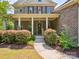 Charming brick home featuring a welcoming front porch with columns and landscaped yard at 2751 Collaroy Rd, Waxhaw, NC 28173
