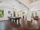 Spacious game room with a pool table, hardwood floors, an adjacent living area, and plenty of natural light at 2751 Collaroy Rd, Waxhaw, NC 28173