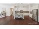 Open kitchen features a large island with seating, stainless appliances, and modern pendant lighting at 2751 Collaroy Rd, Waxhaw, NC 28173