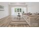Bright living room with neutral tones, modern decor, and light wood flooring at 2751 Collaroy Rd, Waxhaw, NC 28173