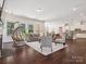 Spacious living room with dark hardwood floors, neutral furniture, and large windows offering ample natural light at 2751 Collaroy Rd, Waxhaw, NC 28173