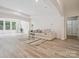 Airy living room showcasing an open floor plan, contemporary decor, and abundant light at 2751 Collaroy Rd, Waxhaw, NC 28173