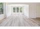 Inviting living room features large windows, archway to connecting room, and sleek hardwood flooring at 2751 Collaroy Rd, Waxhaw, NC 28173