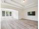 Bright main bedroom with neutral palette, modern lighting, and large windows overlooking green trees at 2751 Collaroy Rd, Waxhaw, NC 28173