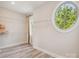 Charming walk-in closet features a circular window with shelving and wood-look flooring at 2751 Collaroy Rd, Waxhaw, NC 28173