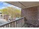 Private balcony with seating offers views of the neighborhood's trees and street at 333 Circle Ave # F, Charlotte, NC 28208