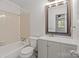 Well-lit bathroom with a shower-tub combo, toilet, and single sink vanity at 333 Circle Ave # F, Charlotte, NC 28208