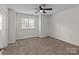 Neutral bedroom featuring a ceiling fan and a window for natural light at 333 Circle Ave # F, Charlotte, NC 28208