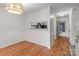 Open dining room featuring hardwood floors, modern lighting, and a pass-through to the kitchen, perfect for entertaining at 333 Circle Ave # F, Charlotte, NC 28208