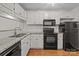 Well-lit kitchen featuring white cabinets, granite countertops, and stainless steel appliances for a modern culinary experience at 333 Circle Ave # F, Charlotte, NC 28208