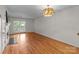 Cozy living room featuring hardwood floors, a sliding glass door, and a fireplace for a comfortable and inviting space at 333 Circle Ave # F, Charlotte, NC 28208