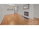 Bright living room with hardwood floors, fireplace, and open staircase creating a welcoming and airy atmosphere at 333 Circle Ave # F, Charlotte, NC 28208