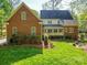 Exterior of the house with well-maintained lawn, garden beds, and a screened in porch at 3667 Saint Andrews Ln, Gastonia, NC 28056