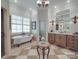 Bright bathroom featuring a clawfoot tub, tiled floors, arched doorway, and vanity at 3667 Saint Andrews Ln, Gastonia, NC 28056