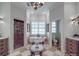 Bright bathroom featuring a clawfoot tub, tiled floors, arched doorway, and dual sink vanities at 3667 Saint Andrews Ln, Gastonia, NC 28056
