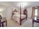 Bedroom featuring a four-poster bed, neutral carpet, chandelier, and luxury decor at 3667 Saint Andrews Ln, Gastonia, NC 28056