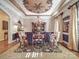 Elegant dining room featuring a decorative ceiling, chandelier, and stylish furnishings at 3667 Saint Andrews Ln, Gastonia, NC 28056