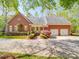 Beautiful brick home with mature landscaping, a circular driveway, and a three car garage at 3667 Saint Andrews Ln, Gastonia, NC 28056