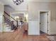 Elegant foyer with hardwood floors, staircase, and view into the living room at 3667 Saint Andrews Ln, Gastonia, NC 28056