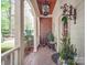 Charming front porch with brick accents, rocking chair, and decorative plant creating a welcoming entrance at 3667 Saint Andrews Ln, Gastonia, NC 28056