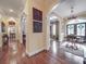 Elegant hallway with arched openings, hardwood floors, and decorative wall panels at 3667 Saint Andrews Ln, Gastonia, NC 28056