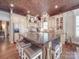 Gourmet kitchen boasts custom cabinets, large island, and unique copper ceiling at 3667 Saint Andrews Ln, Gastonia, NC 28056