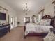 Spacious main bedroom featuring a chandelier, luxury furniture and neutral decor at 3667 Saint Andrews Ln, Gastonia, NC 28056