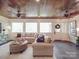 Cozy sun room with wood ceiling, large windows, and comfortable seating at 3667 Saint Andrews Ln, Gastonia, NC 28056