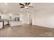 Open floor plan with luxury vinyl plank flooring, white cabinets, and stainless steel appliances at 4040 Bolo Dr, Charlotte, NC 28215