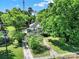 An aerial view showcasing a home with mature trees and expansive driveway at 407 Chesterfield Ave, Lancaster, SC 29720