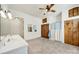 Spacious bathroom featuring double sink vanity, storage shelves, wood cabinets, and ceiling fan at 407 Chesterfield Ave, Lancaster, SC 29720