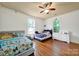 Bedroom with hardwood floors featuring two beds, a window, and a dresser at 407 Chesterfield Ave, Lancaster, SC 29720