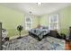 Bright bedroom with green walls, windows and a cozy bed at 407 Chesterfield Ave, Lancaster, SC 29720