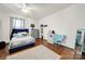 Bedroom featuring wood floors, ceiling fan, closet, accent furniture, and natural light at 407 Chesterfield Ave, Lancaster, SC 29720